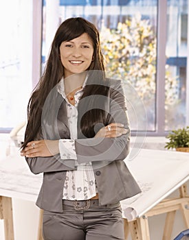 Pretty businesswoman standing in office