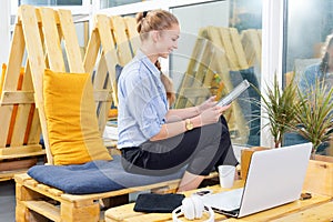 Pretty businesswoman working with new startup project using tablet in modern loft. Woman in businness.