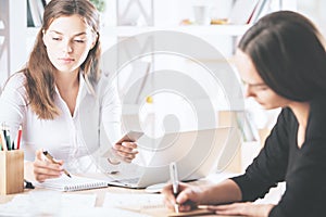 Pretty businesswomen doing paperwork