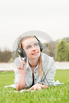 Pretty carefree girl listening music during recreation time