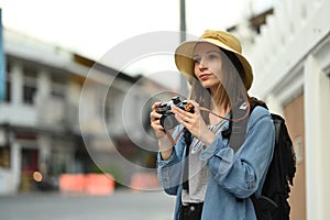 Pretty caucasian female traveller with backpack walking in old city in Chiang Mai Northern Thailand