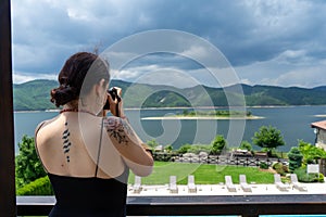 Pretty Caucasian Journalist Woman with tattoo in the back working outside