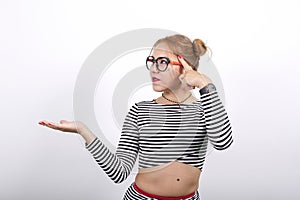 Pretty caucasian woman making the gesture of madness putting finger on the head