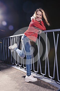 Pretty Caucasian Woman In Red Leather Jacket and Blue Jeans