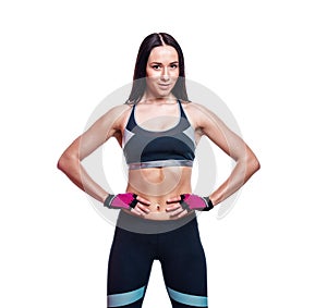 Pretty caucasian young sporty muscular woman on white isolated background. Athletic bodybuilder girl or fitness instructor