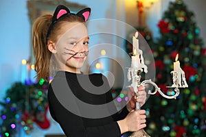 Beautiful charming pretty blond child-girl on the background of a New Year tree photo