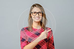 Pretty cheerful woman gesturing with fingers and hand and showing away