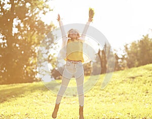 Pretty cheerful woman having fun in sunny autumn day