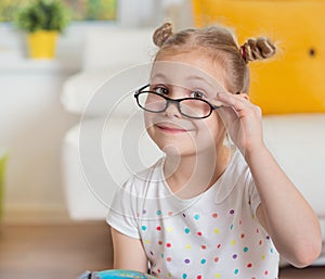 Pretty child girl at home dreaming of travel and tourism, exploring the world and globe