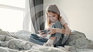 Pretty child girl playing games on smartphone