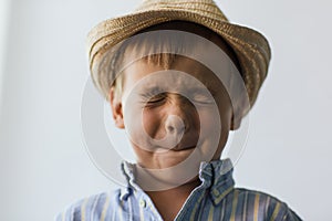 The pretty child in the straw hat closed his eyes
