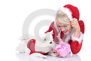 Pretty christmas woman with white dog and gift box