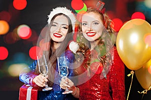 Pretty Christmas women on abstract bokeh glitter sparkle party background