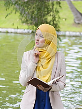 Pretty college student enjoy reading in the park