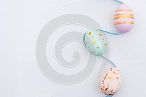 Pretty Colored Easter Eggs on blue Ribbon isolated on white background with copy space