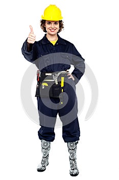 Pretty construction worker gesturing success