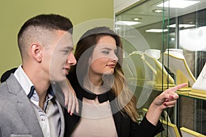 Pretty Couple Looking at Jewelry in Store Window