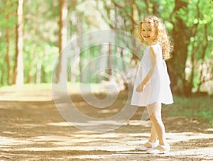 Pretty curly little girl in summer