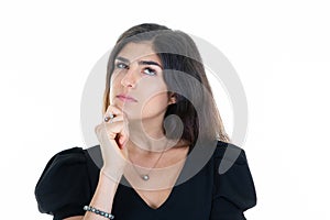 Pretty cute pensive woman looks up side on white background