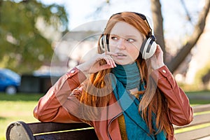 Pretty cute woman listening to music using headphones