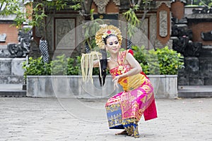 Pretty dancer performing traditional Balinese dance