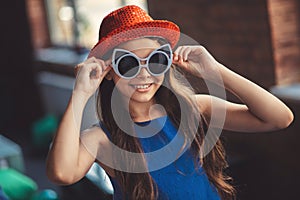 Pretty dark-haired girl in eyeglasses looking happy