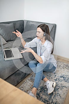 A pretty dark-haired operator of call canter working from home