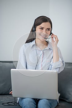 A pretty dark-haired operator of call canter working from home