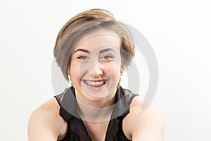 pretty dark haired teenage girl with braces smiling