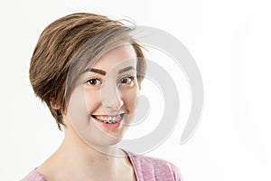 pretty dark haired teenage girl with braces smiling