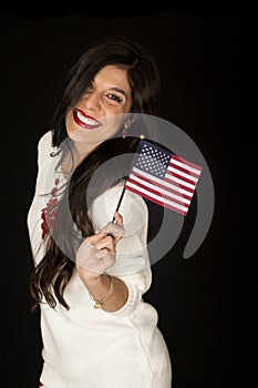 Pretty dark haired woman smiling holding an American flag