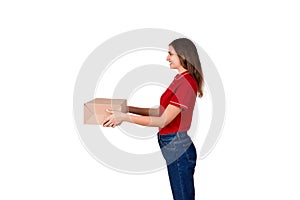 Pretty delivery girl is giving a cardboard box to a customer isolated on white background