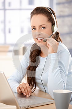 Pretty dispatcher working in call center smiling