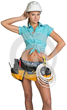 Pretty electrician in helmet, shorts, shirt, tool