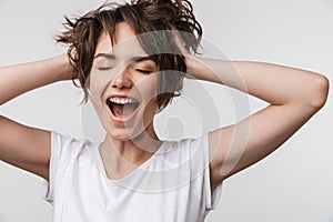 Pretty excited happy woman posing isolated over white wall background laughing