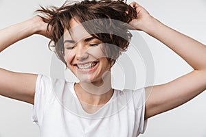 Pretty excited happy woman posing isolated over white wall background laughing