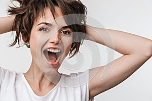 Pretty excited happy woman posing isolated over white wall background laughing