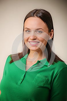 pretty excited woman happy smile, young attractive girl wear green shirt, light grey background