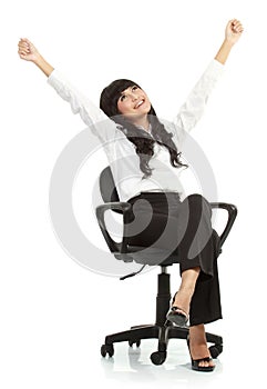 Pretty excited young woman sitting on chair