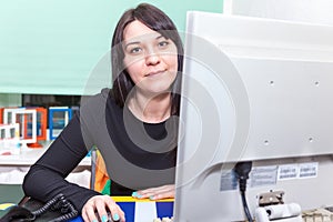 Pretty execute woman behind computer