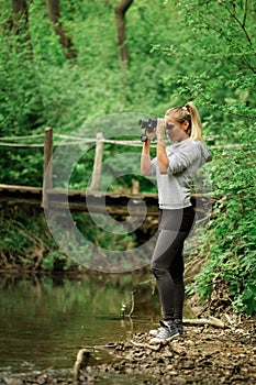 Pretty explorer woman with binoculars