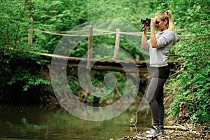 Pretty explorer woman with binoculars