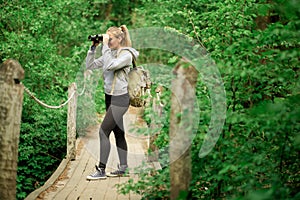 Pretty explorer woman with binoculars