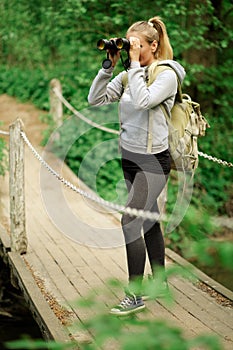 Pretty explorer woman with binoculars