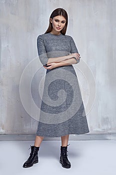 pretty fashion woman wear wool grey dress casual trend clothes collection catalogue brunette hair party style model pose