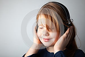 Pretty fat girl listening to music in delight. Fascinated by the song