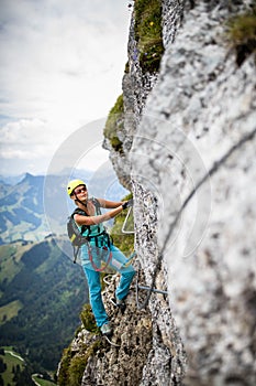 Pretty, female climber on a via ferrata