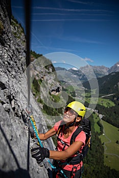 Pretty, female climber on a via ferrata