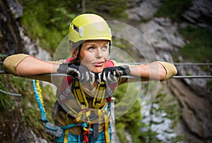 Pretty, female climber on a via ferrata