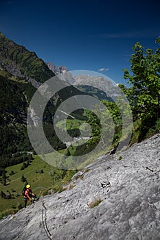 Pretty, female climber on a via ferrata